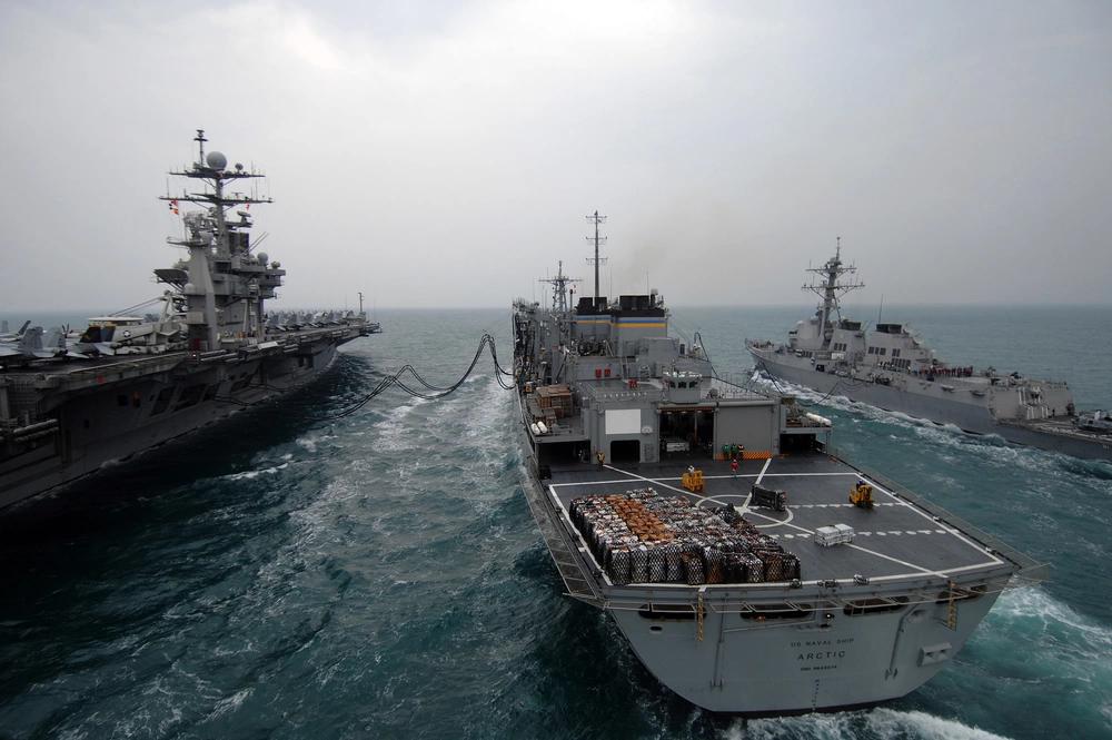 Warships in ocean refueling operation.